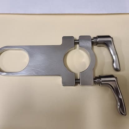A machined clamp assembly fitted with two chrome locking levers