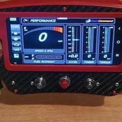 A carbon fibre racing steering wheel fitted with a digital performance display